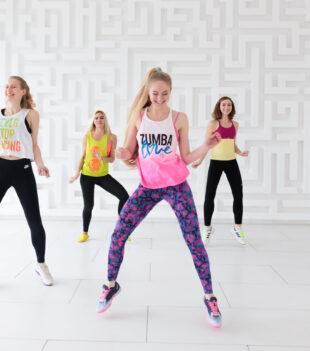 RUSSIA, MOSCOW, 2017 - MARCH 12: Happy young women in sportswear at Zumba dance fitness class in dance studio